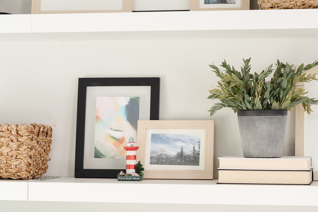 shelf decor with picture frames and mementos