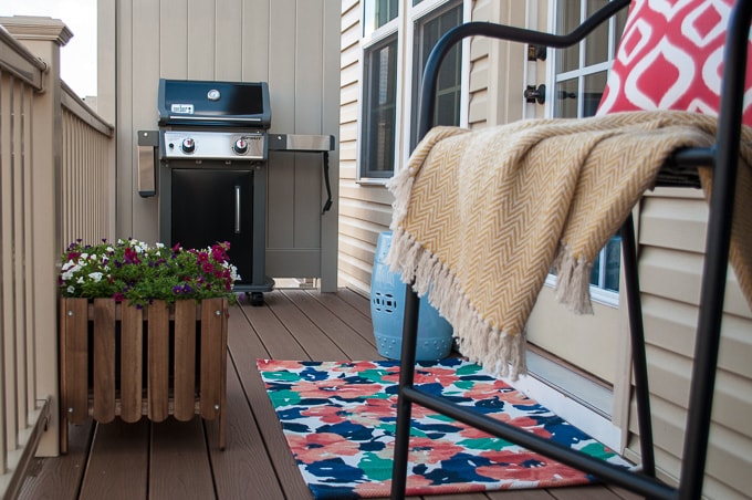 Look at how she decorates this small space townhome porch! Perfect for summer! I love all the bright colors