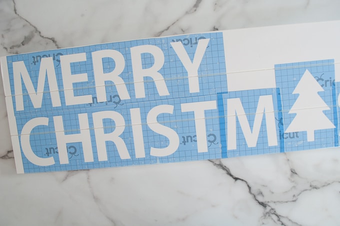 Tutorial for making a DIY Merry Christmas wooden sign. Such a great Christmas decoration craft! Make the stencil using your Cricut Explore!