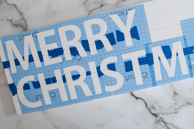 Tutorial for making a DIY Merry Christmas wooden sign. Such a great Christmas decoration craft! Make the stencil using your Cricut Explore!