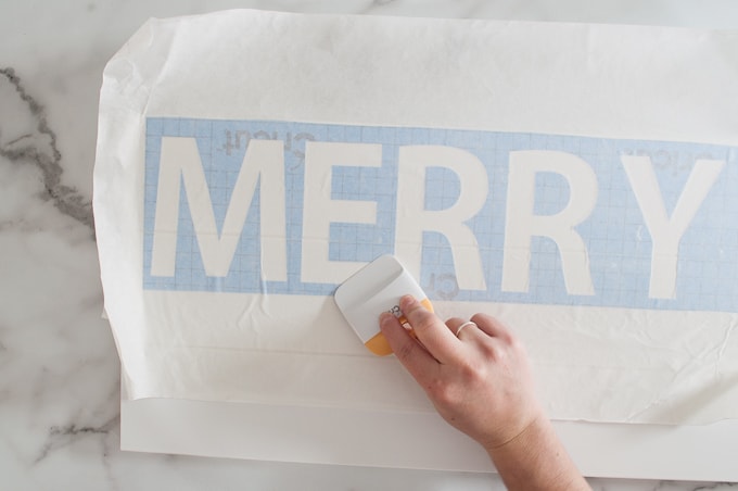 Tutorial for making a DIY Merry Christmas wooden sign. Such a great Christmas decoration craft! Make the stencil using your Cricut Explore!