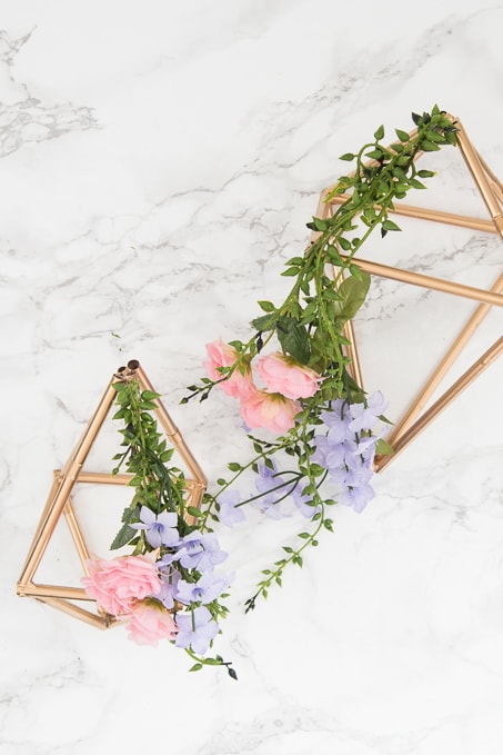 Pretty idea and unique take on a spring wreath! This geometric floral door hanger is gorgeous and a budget friendly way to create a unique spring decoration.