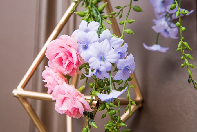 Pretty idea and unique take on a spring wreath! This geometric floral door hanger is gorgeous and a budget friendly way to create a unique spring decoration.