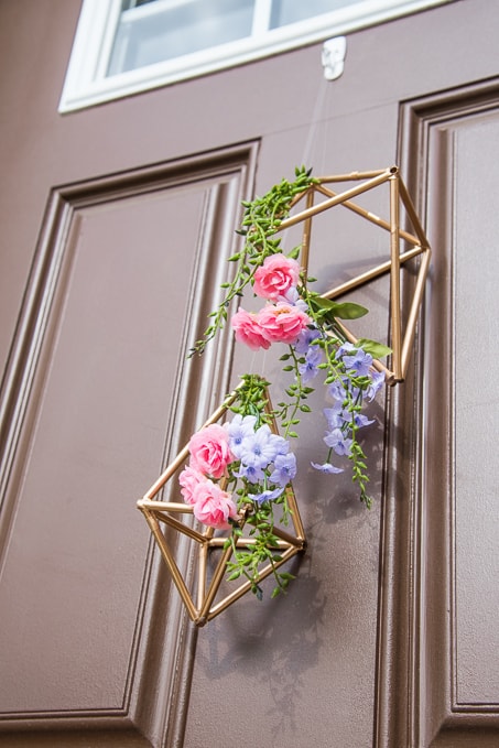 Pretty idea and unique take on a spring wreath! This geometric floral door hanger is gorgeous and a budget friendly way to create a unique spring decoration.