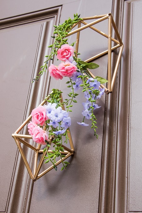 Pretty idea and unique take on a spring wreath! This geometric floral door hanger is gorgeous and a budget friendly way to create a unique spring decoration.