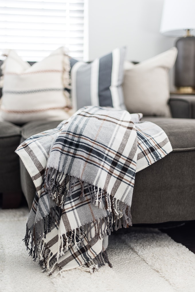 gray and white plaid throw blanket on a couch