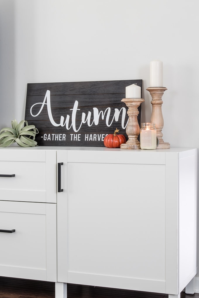 black and white wooden autumn sign on a white cabinet