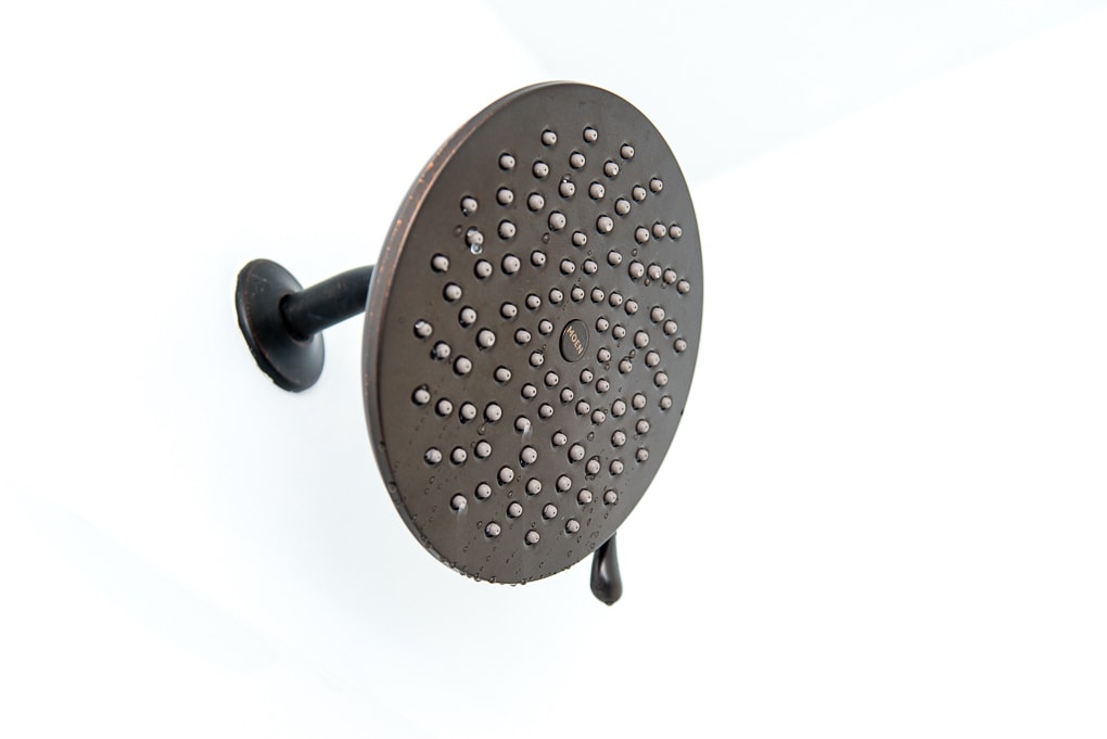 Close up of a Moen Velocity Shower Head in oil rubbed bronze