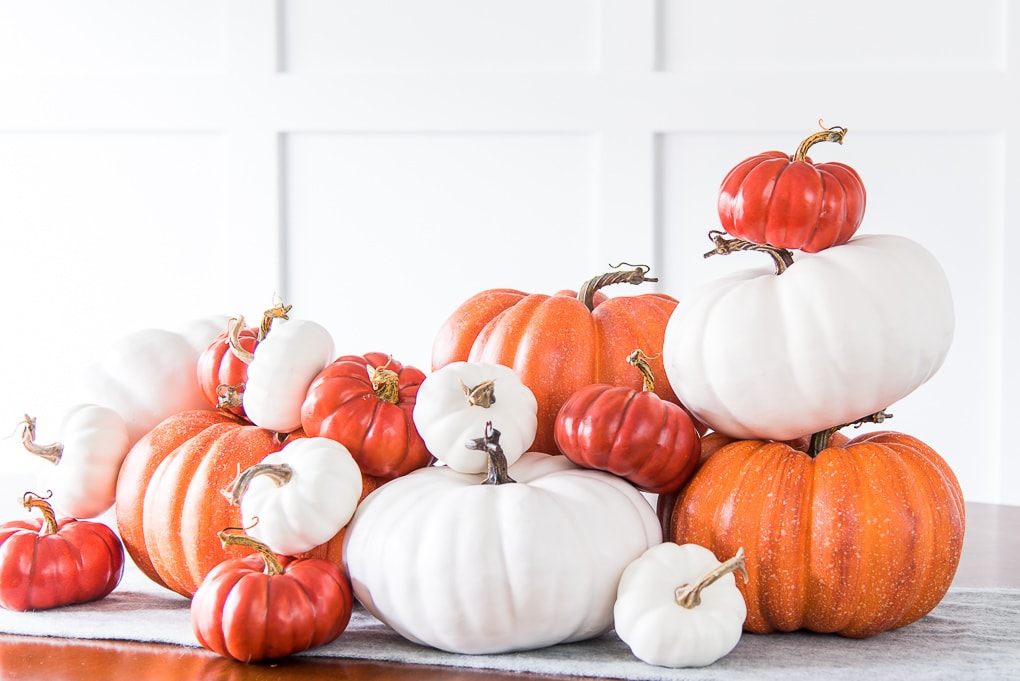 pile of orange and white pumpkins stacked