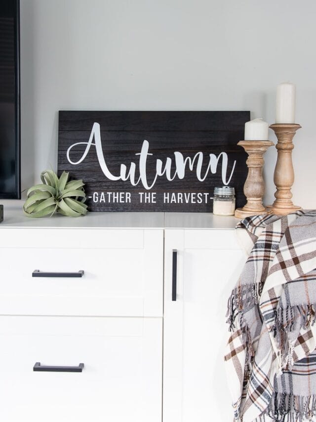 Wooden Autumn Hand-Lettered sign vignette on a media center with fall accessories