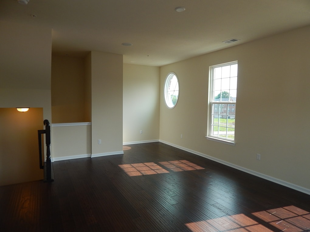 yellow empty living room builder grade home