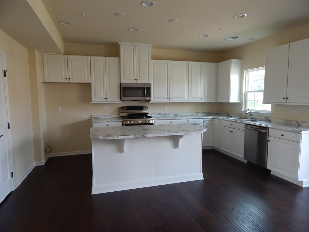 yellow and white empty kitchen builder grade home