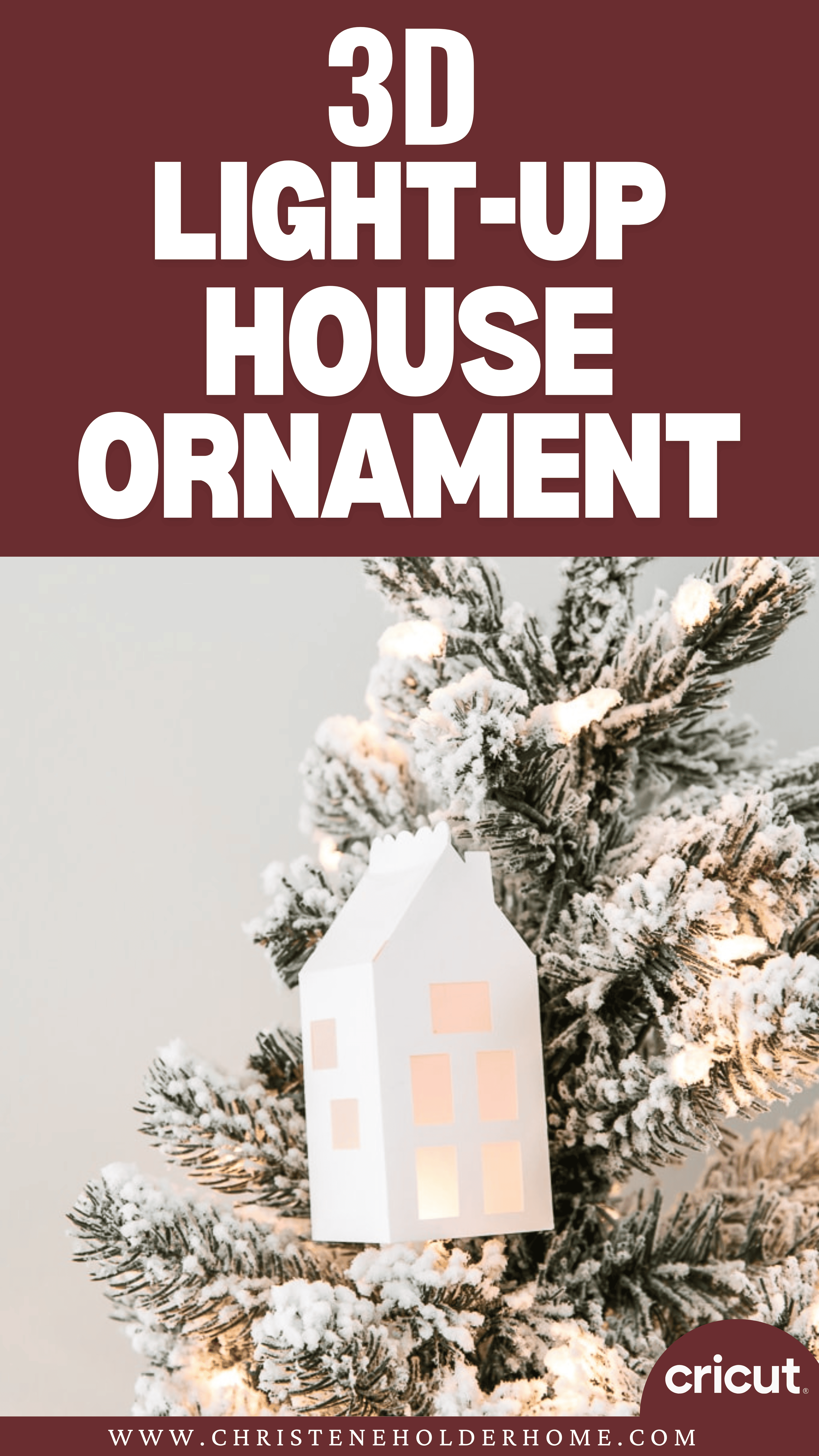 A white 3D paper house ornament with windows glows warmly as it hangs on a snow-dusted Christmas tree branch. The background showcases the text "3D Light-Up House Ornament" alongside the Cricut logo, bringing a modern touch that beautifully complements your merry Christmas décor.