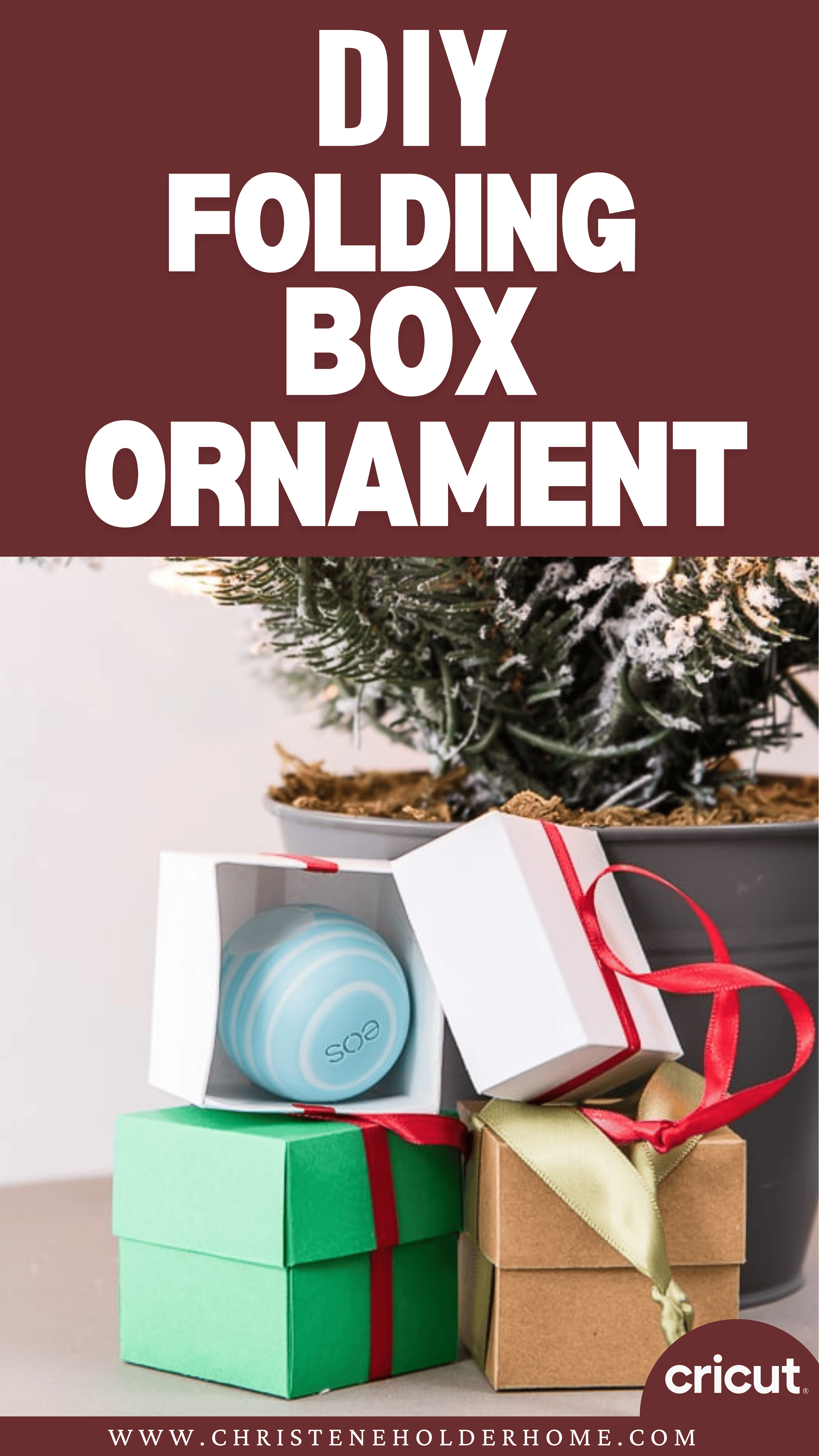 A stack of small, elegantly wrapped boxes with ribbons sits next to an open box unveiling a circular ornament inside. In the background, a Christmas tree twinkles softly. At the top, the text reads "DIY Folding Gift Box Ornament.