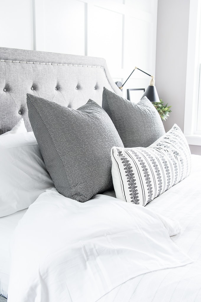 master bedroom bed white bedding gray pillows