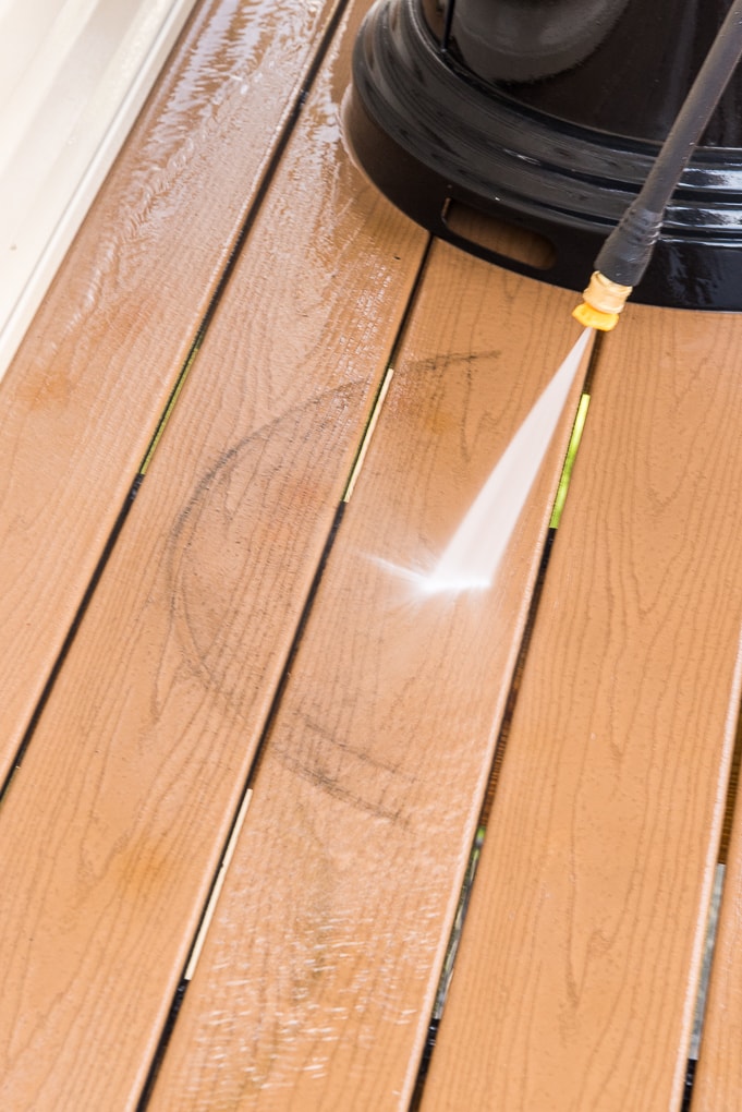 power washing a deck floor with Ryobi power washer