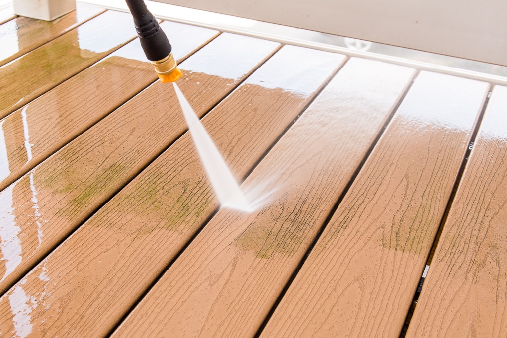 removing grime from deck with Ryobi power washer