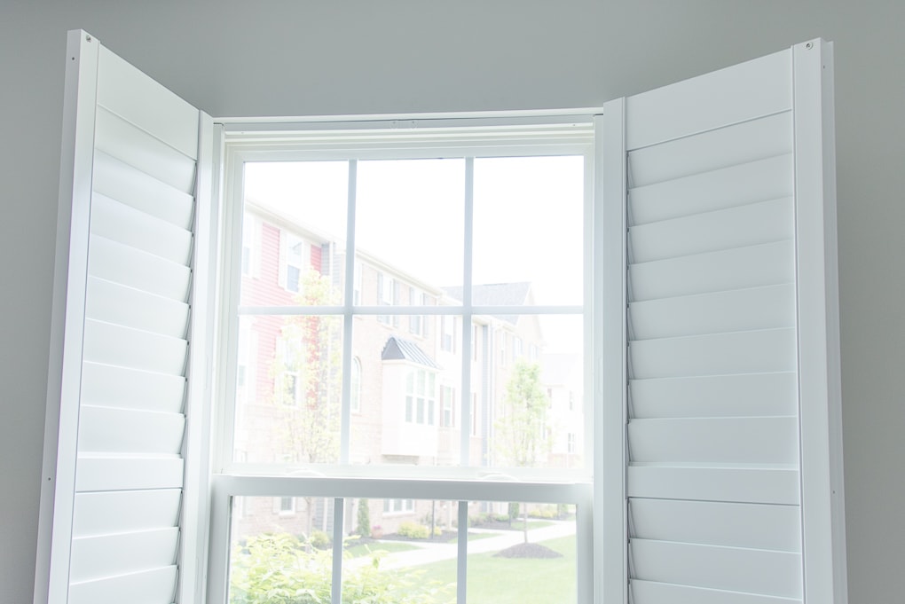 white plantation shutters open with a magnetic strip