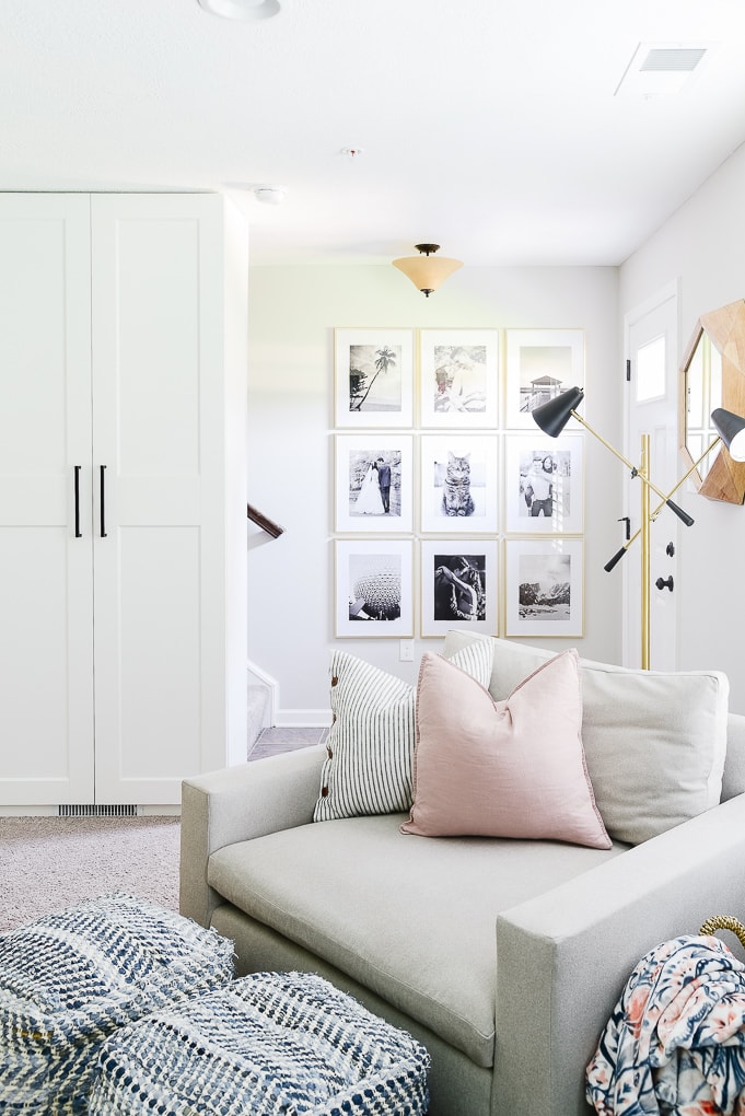 black and white gallery wall with gold frames in entry