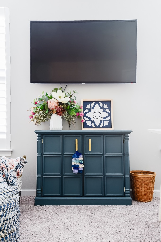 blue cabinet with tv mounted on the wall