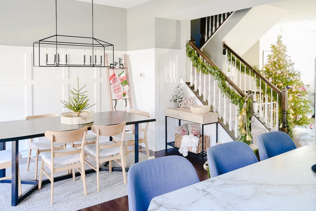 Christmas dining room decorated with festive modern styled decor and stocking ladder