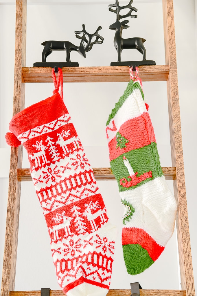 red and green knitted stockings on ladder