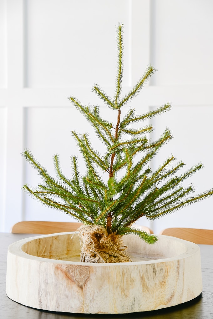 tabletop sparse Christmas tree in wooden round tray