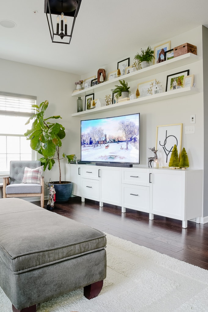 white IKEA media center decorated for Christmas in living room with IKEA LACK shelves above the TV