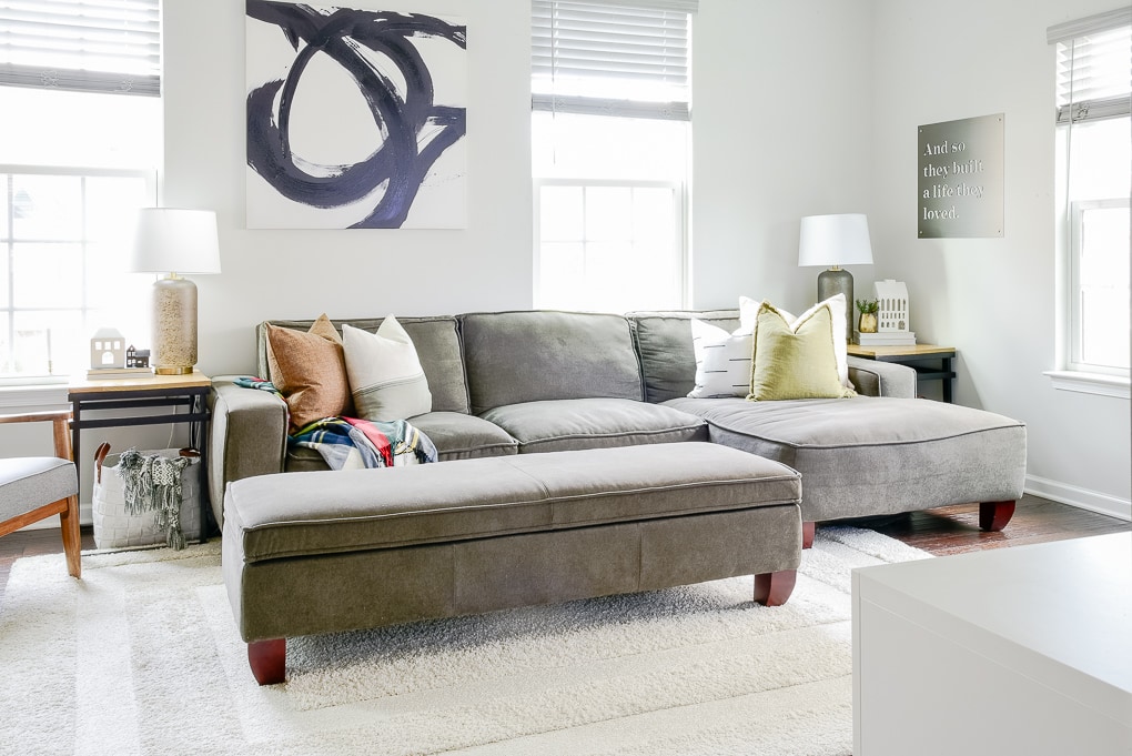 modern classic living room decorated for Christmas gray sectional couch with throw pillows