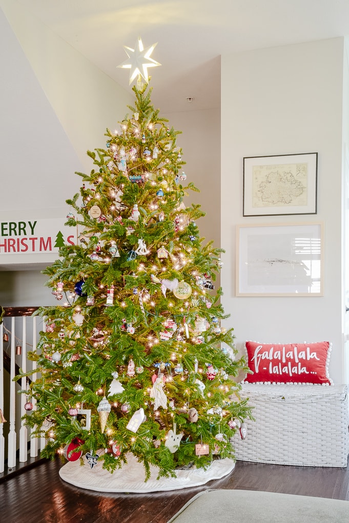 fresh Christmas tree decorated in modern classic living room with family ornaments