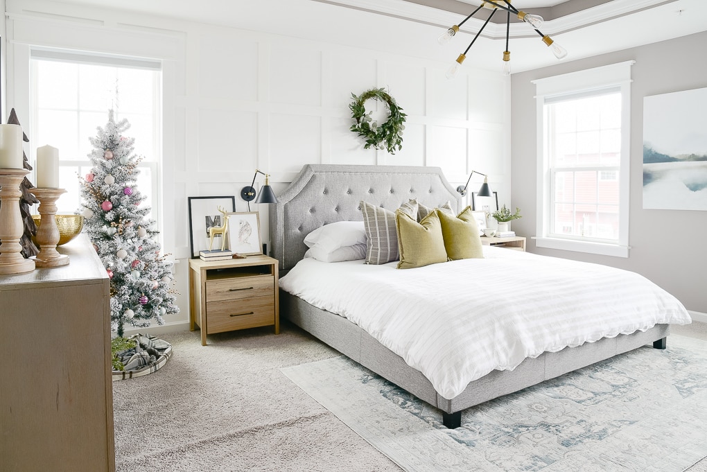 modern and natural christmas bedroom with flocked christmas tree in the corner