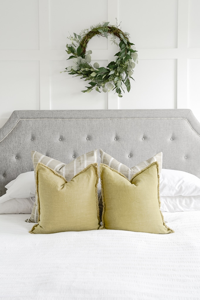 olive green pillows on white bedding in master bedroom