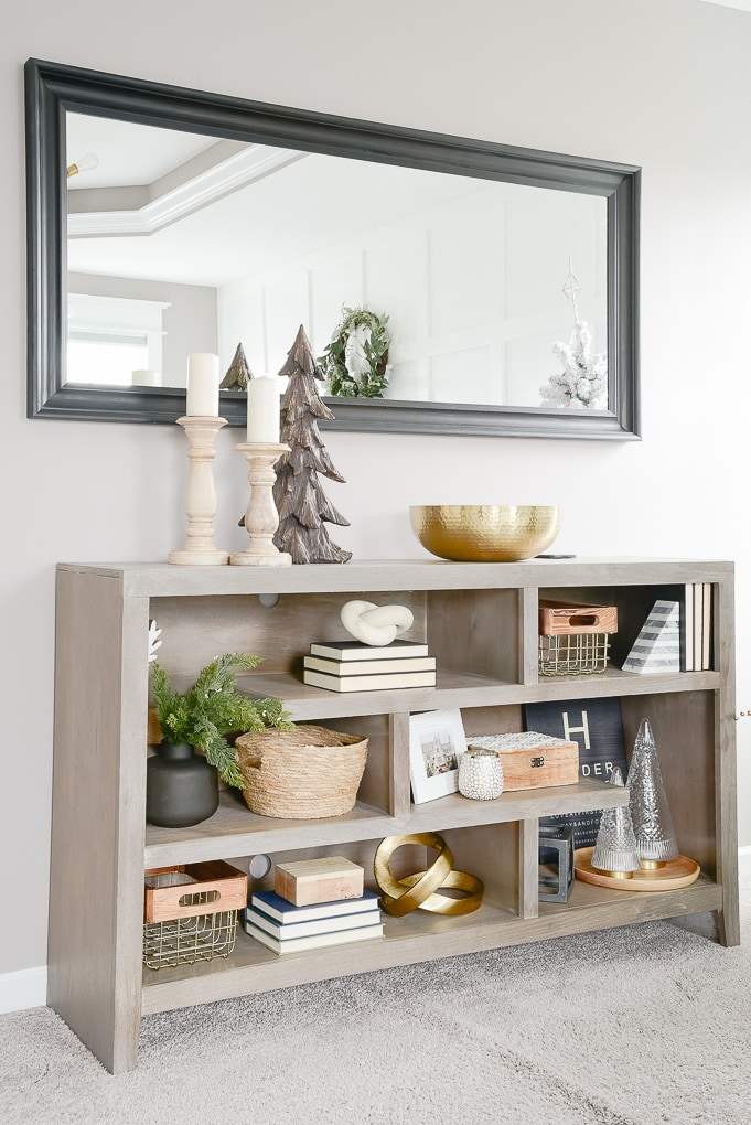 styled and decorated gray bookshelf in master bedroom decorated for christmas