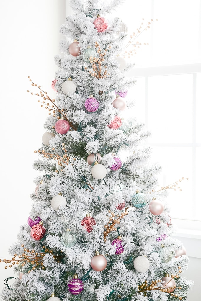 colorful ornaments on flocked decorated christmas tree