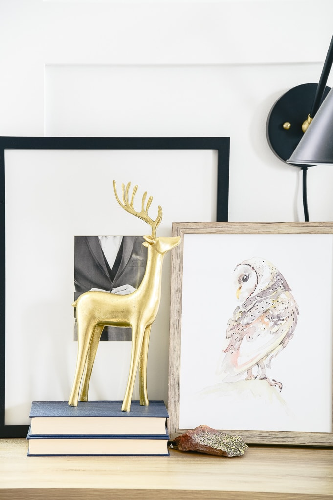 gold reindeer figurine on books on nightstand in master bedroom decorated for christmas