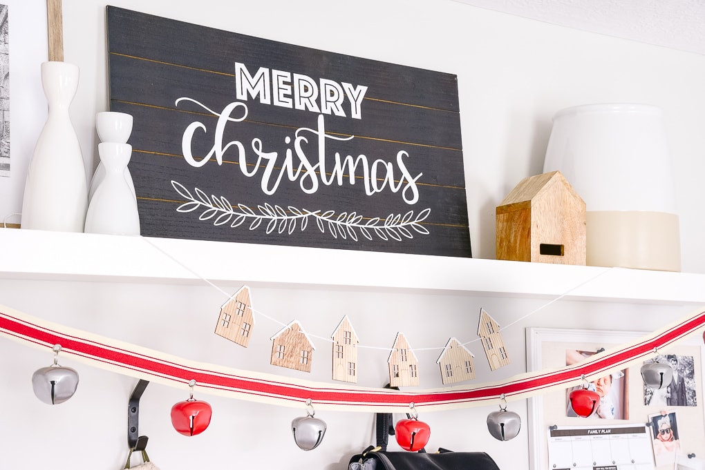 merry christmas black and white sign on white shelf in a mudroom