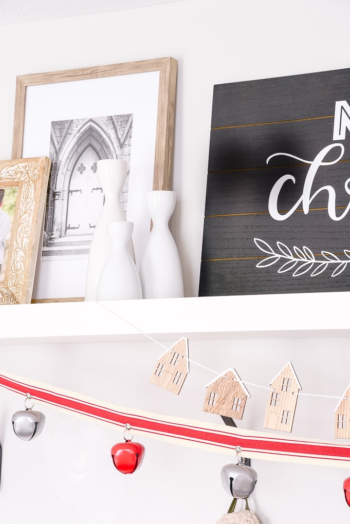 white candle holders on white shelf decorated mudroom christmas