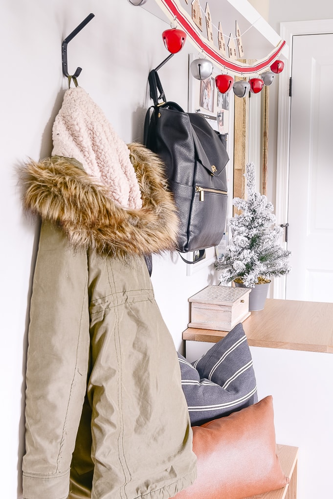 coats hanging in mudroom decorated for christmas