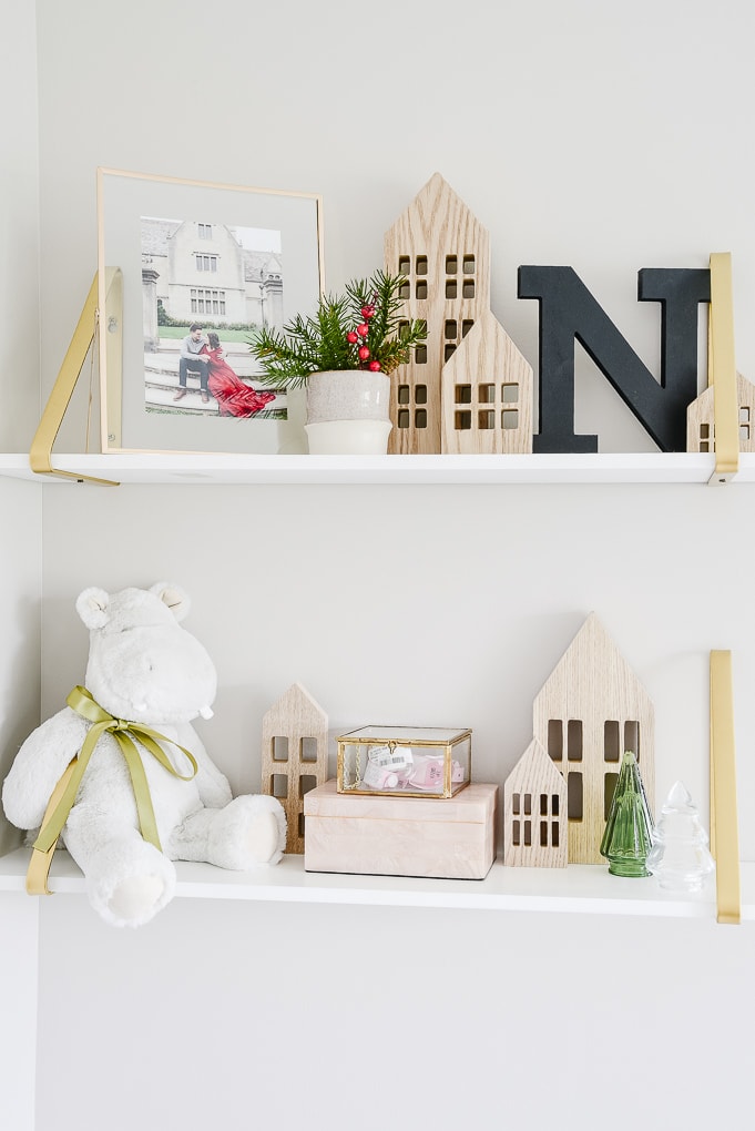 decorated white and gold shelves for Christmas in nursery