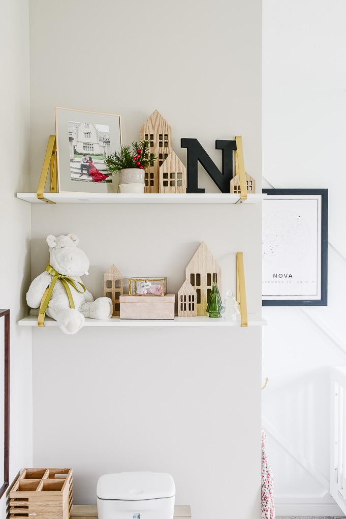 white and gold shelves in a nursery decorated for Christmas