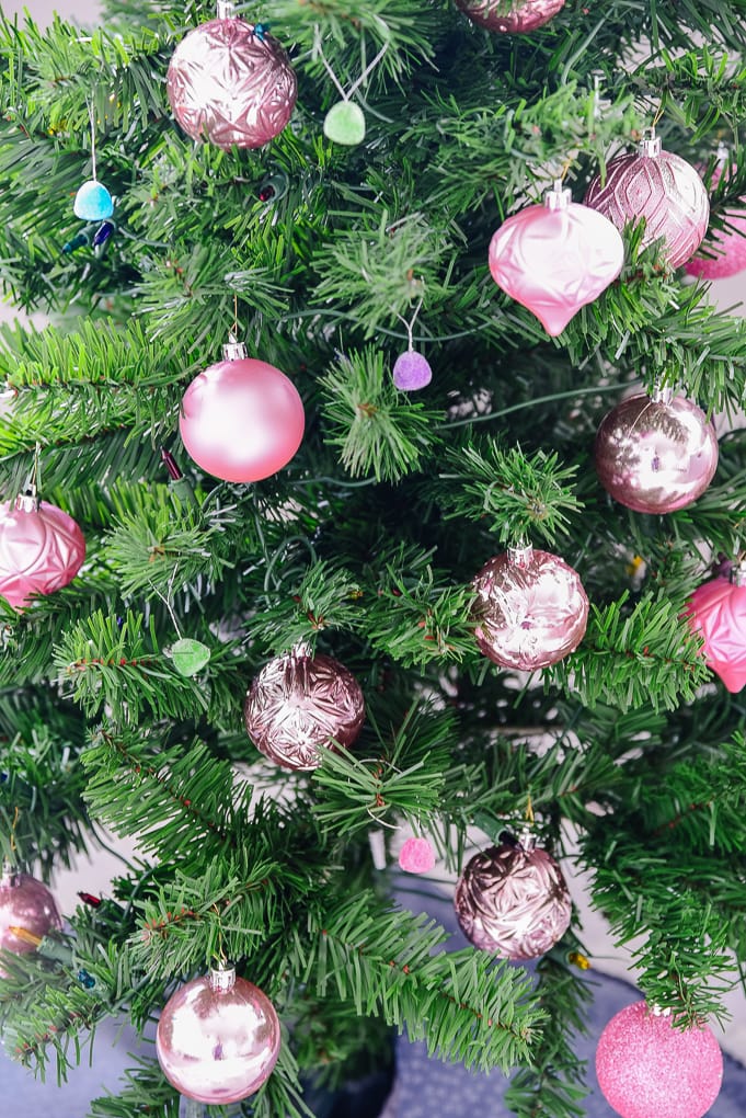 pink shatterproof ornaments on Christmas tree