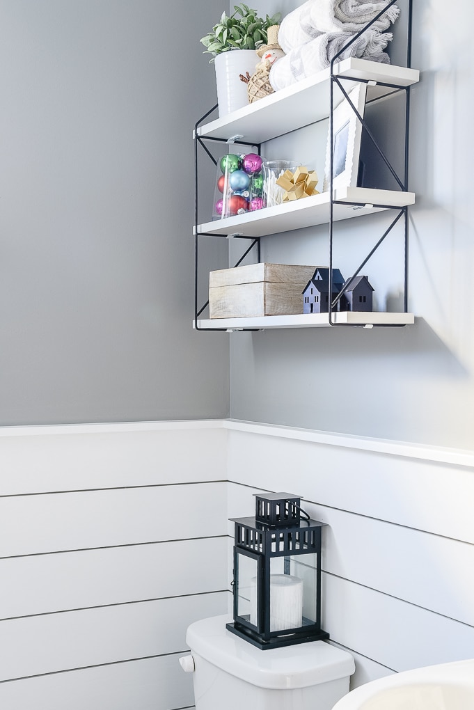 shiplap powder room decorated for Christmas with black lantern