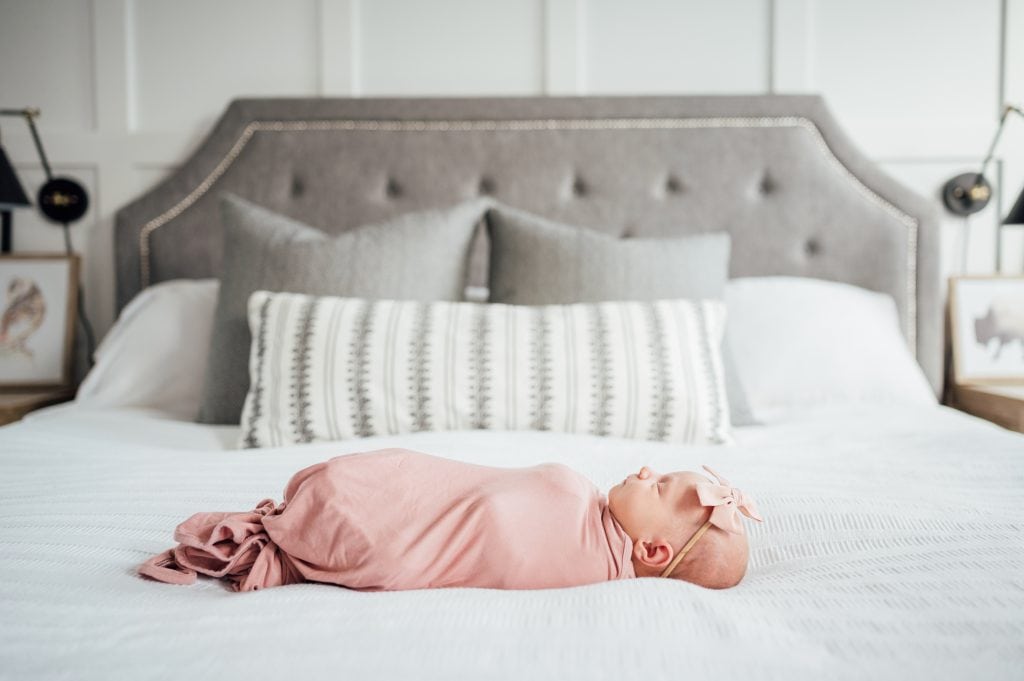 newborn baby on a bed