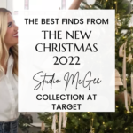 A woman decorates a Christmas tree with a smile. Overlaid text reads, "The Best Finds From The New Studio McGee Target Christmas Collection 2022." The background shows festive decorations and a website link at the bottom: christeneholderhome.com.