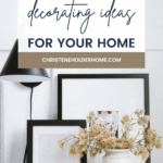 A styled home décor setup featuring brown floral arrangements in white vases, black picture frames with minimalistic art, and a black table lamp. A banner at the top reads, "The Best Fall Decorating Ideas for Your Home" with a website link below. Discover inspiring fall decorating ideas today!