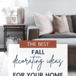 A cozy living room with a gray sofa adorned with brown and beige pillows. A side table holds a lamp, framed picture, and small decorations. Below, a text overlay reads, "The Best Fall Decorating Ideas for Your Home," christeneholderhome.com.