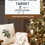 A cozy Christmas scene featuring a small decorated tree with lights and ornaments, a cream-colored armchair with a snowflake-patterned pillow and plaid throw blanket. A wrapped gift sits at the base of the chair. Text reads "Hearth and Hand with Magnolia Target Christmas Collection.