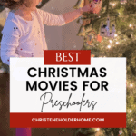 A young girl in a white sweater and pink pants decorates a Christmas tree. The image features a text overlay that reads "Best Christmas Movies for 4 Year Olds," along with a website URL, "christeneholderhome.com," at the bottom.